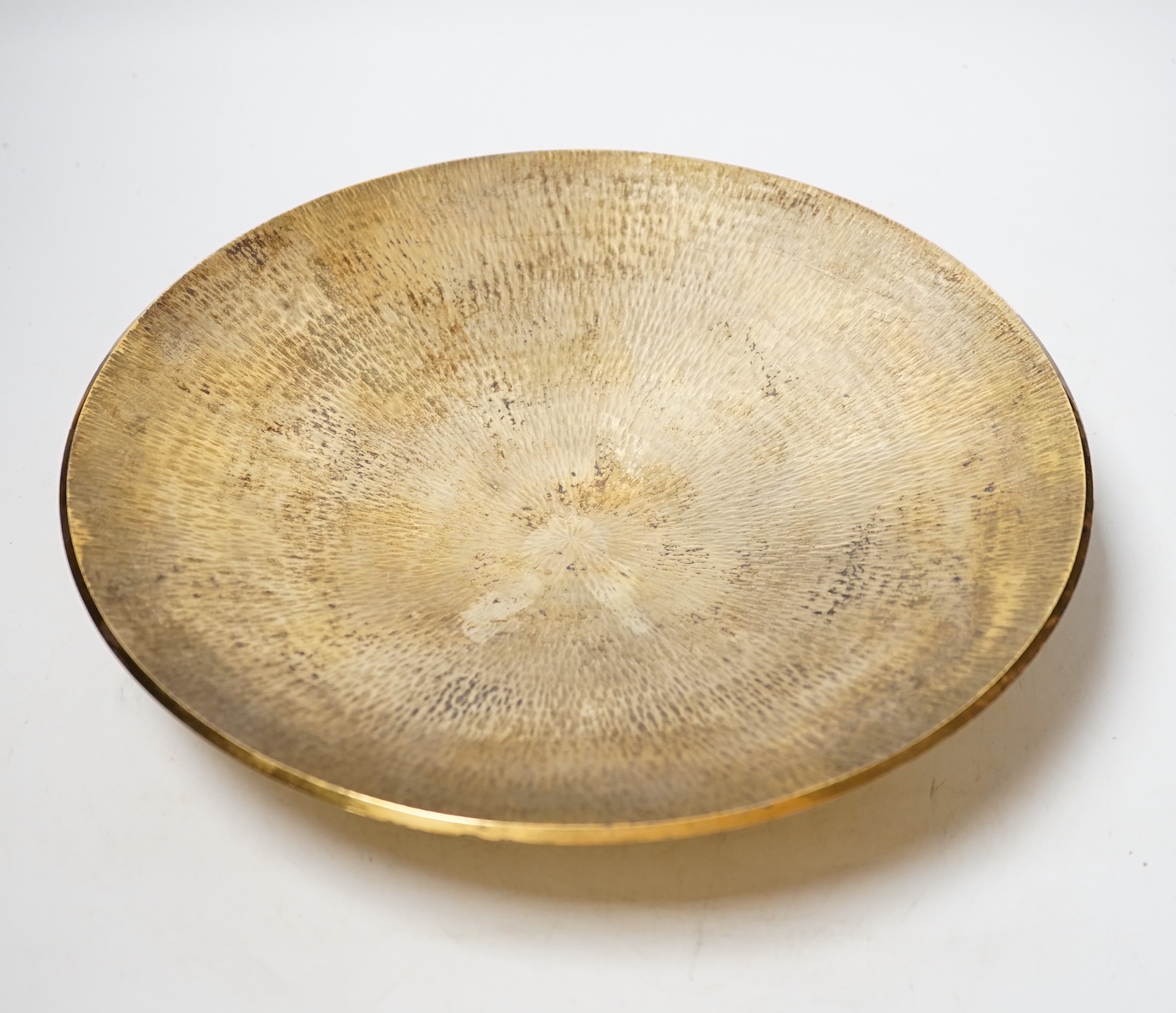 A modern planished silver gilt shallow dish, on circular foot, maker TS, London, 1996, 28.2cm, 24.4oz.